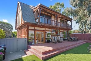 a house with a deck in a yard at European Elegance by the Sea in Pacific Palisades