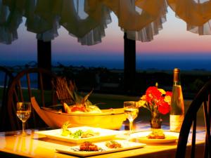a table with two plates of food and a boat at Koibito Misaki Pension Marine Mates in Izu +38 photos