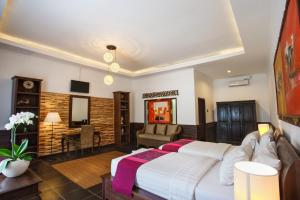 Letto o letti in una camera di Ubud Raya Boutique Hotel