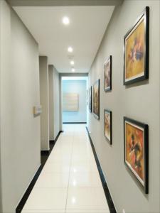 a hallway in a hospital with paintings on the walls at Rivero Boutique Hotel Melaka in Melaka