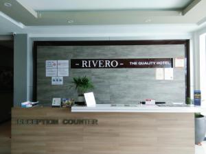 a reception counter in a building with a sign on it at Rivero Boutique Hotel Melaka in Malacca