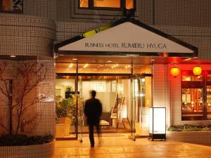 a man walking out of a store front at Hotel Rumieru Hyuga in Hyuga