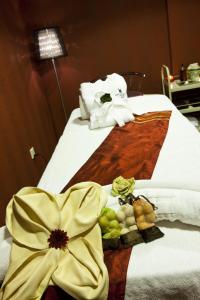 a hotel room with a bed with a yellow flower on it at Kingsgate Hotel Doha by Millennium Hotels in Doha