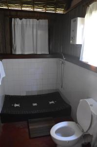 a bathroom with a toilet and a sink at Maningory in Ile aux Nattes