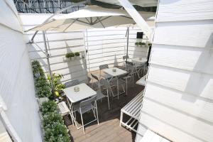 an overhead view of a patio with tables and an umbrella at Travelogue Guest House in Kuala Lumpur