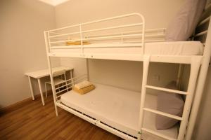 a room with two bunk beds in a room at Travelogue Guest House in Kuala Lumpur