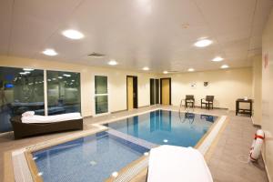 a large swimming pool in a hotel room at Kingsgate Hotel Doha by Millennium Hotels in Doha