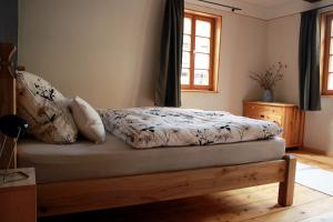 a bedroom with a bed with a wooden bed frame at Ferienhaus Kaisereins in Quedlinburg