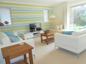 a living room with a couch and a tv at Luxury 4 Bed 3 Bathroom Bungalow , South West of London, The Dapples in Epsom