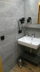 a bathroom with a sink and a wall at Haus Bergkristall in Sankt Anton am Arlberg