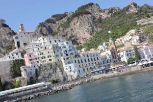 a group of buildings on a mountain next to the water at Casa Vacanze Nonna Raffa in Amalfi