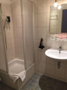 a bathroom with a shower and a sink at Pension Tempelhof in Berlin