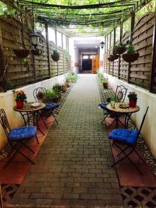 a patio with tables and chairs in a building at Pension Tempelhof in Berlin