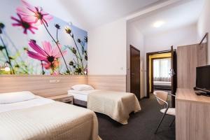 Un pat sau paturi într-o cameră la Hotel Nosselia