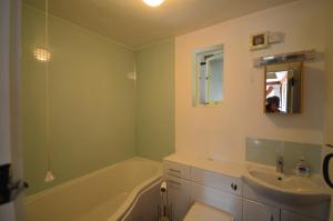 a bathroom with a bath tub and a sink at Whitewells Farm Cottages in Great Malvern +59 photos
