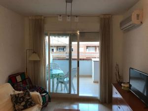 a living room with a sliding glass door to a patio at Apartamento en Oropesa del Mar in Oropesa del Mar