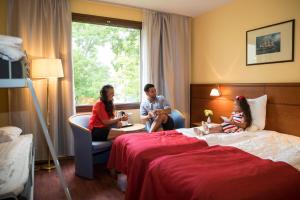a group of people sitting in a hotel room at Hotel Savoy in Mariehamn