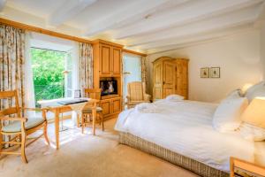 - une chambre avec un lit, un bureau et une fenêtre dans l'établissement A La Cour d'Alsace by HappyCulture, à Obernai