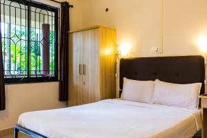 Ein Bett oder Betten in einem Zimmer der Unterkunft Lazy Frog Guest House