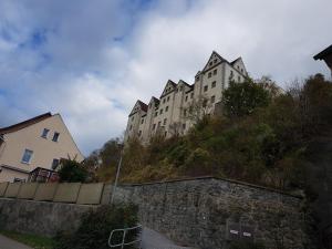 a large building on the side of a hill at Monteurzimmer Fuchs-Kupke in Siebenlehn