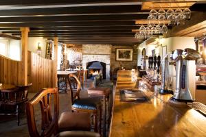 a bar with chairs and a fireplace in a restaurant at Black Horse Beamish in Stanley