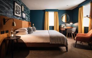 a bedroom with a bed and a desk and a chair at Hotel Du Vin Stratford in Stratford-upon-Avon