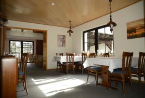 a dining room with a white table and chairs at Hotel Leise Garni in Willingen