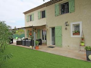 uma casa com portas verdes e um quintal em Tasteful Villa in Montauroux with Private Pool em Montauroux