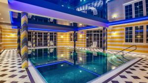 a swimming pool in the middle of a house at Apartamenty M&M in Mikołajki