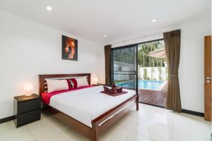 a bedroom with a bed and a pool at Villas Eden in Lamai +17 photos