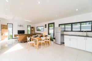 a kitchen and living room with a table and chairs at Villas Eden in Lamai