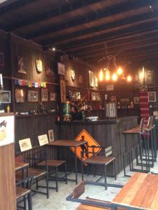 a room with a table and chairs and a bar at The Shadow House & Bar in Ko Phayam +28 photos