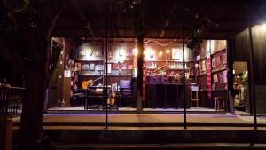 a stage with a group of people in a room at The Shadow House & Bar in Ko Phayam