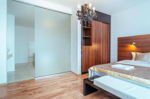 Кровать или кровати в номере Apartamenty M&M
