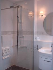 a glass shower in a bathroom with a sink at Gower View Luxury Bed & Breakfast in Tenby