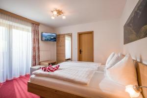 a bedroom with a large bed in a room at Pension Sonnblick in Westendorf