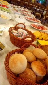 a table with baskets of bread and other foods at Dom Młynarza in Żukczyn