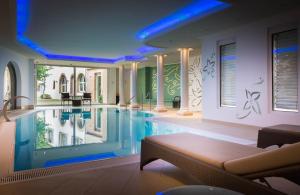 a large swimming pool in a house at Hotel & Spa A la cour d'Alsace by HappyCulture in Obernai
