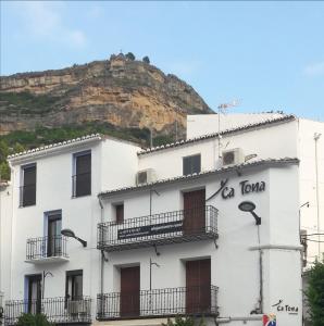 un bâtiment blanc avec une montagne en arrière-plan dans l'établissement Casa Rural "ca Tona", à Chulilla