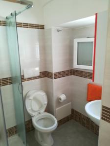 a bathroom with a toilet and a sink at Alba Dorata in Casarano
