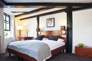 a bedroom with a large bed with a wooden headboard at Hapimag Apartments Amsterdam in Amsterdam