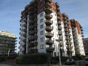 a tall apartment building with balconies on it at De Panne Plaza in De Panne +15 photos