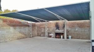 a garage with awning over a brick wall at Departamentos San Jorge in Santa Rosa