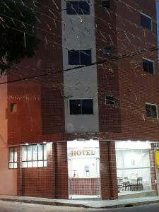 a brick building with a hotel on the side of it at Hotel Santos Reis in Aparecida