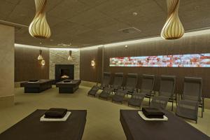 a conference room with chairs and a fireplace at Sunday Hotel Friedrichroda & SPA in Friedrichroda