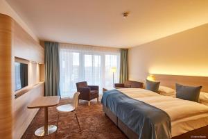 a hotel room with a large bed and a window at Hotel Schelf GmbH & Co. KG in Büsum