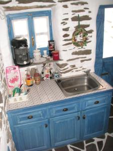 a blue kitchen counter with a sink in a room at 3-level doll house in Kea Ioulida/Chora, Cyclades in Ioulis