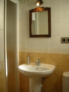 a bathroom with a sink and a mirror and a toilet at Ribera del Sella in Cangas de Onís +42 photos