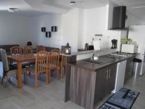a kitchen and dining room with a table and chairs at Les gîtes du Thouet in Saint Loup Lamaire