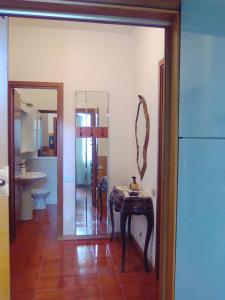 Habitación con mesa y baño con espejo. en Lorenzo Apartment en Levanto